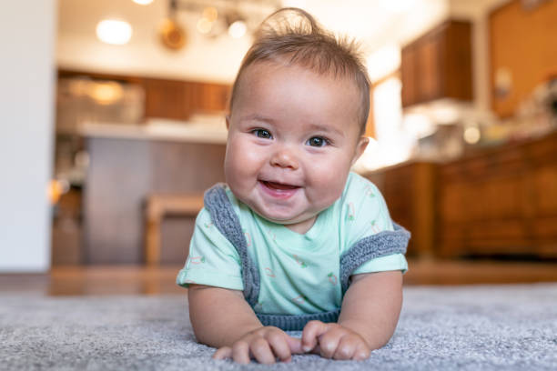 Baby laying on carpet floorings | Birons Flooring Inc